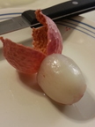 Peeled lychee berry with paring knife